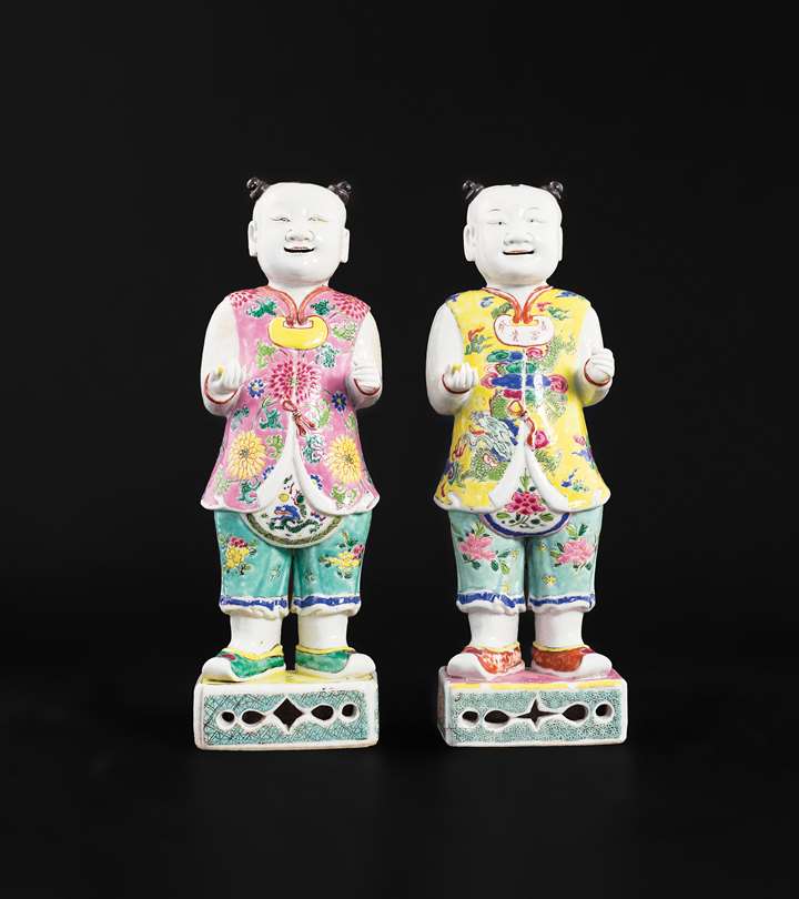 Pair of chinese export porcelain famille rose figures of standing boys